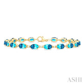 6X4 MM Oval Cut Blue Topaz and 1/6 Ctw Round Cut Diamond Semi-Precious Tennis Bracelet in 10K Yellow Gold