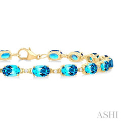 6X4 MM Oval Cut Blue Topaz and 1/6 Ctw Round Cut Diamond Semi-Precious Tennis Bracelet in 10K Yellow Gold