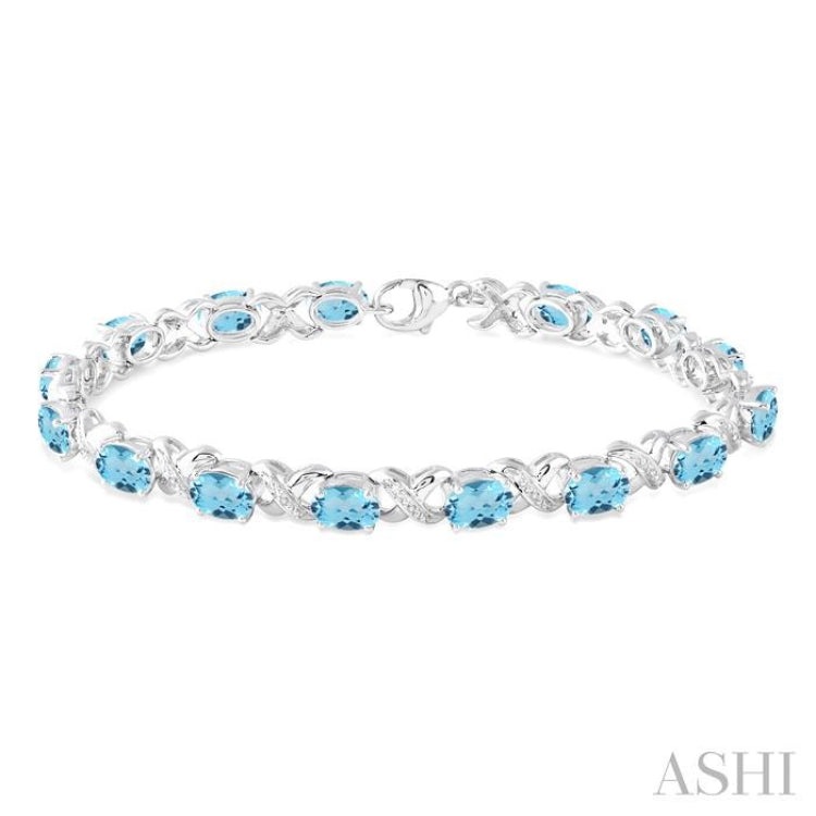 7x5 MM Oval Cut Blue Topaz and 1/20 Ctw Round Cut Diamond Fashion Bracelet in Sterling Silver